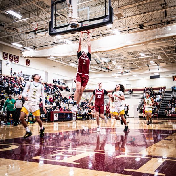Basketball player dunking during game coverage