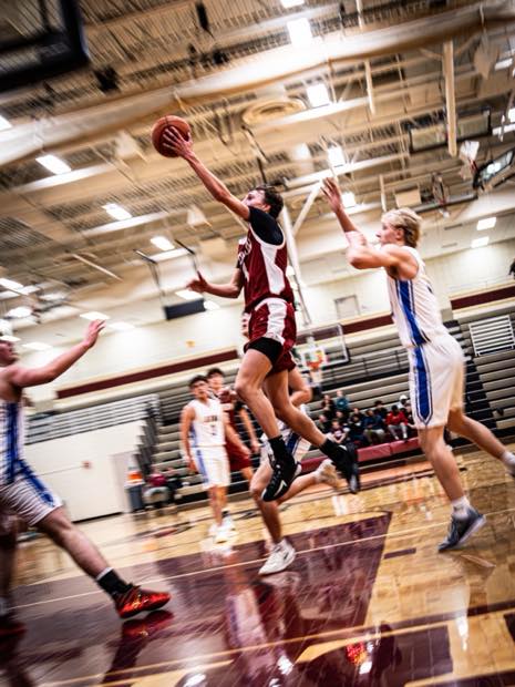 Basketball player driving toward the basket