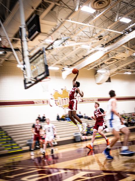 Basketball player going up for a layup